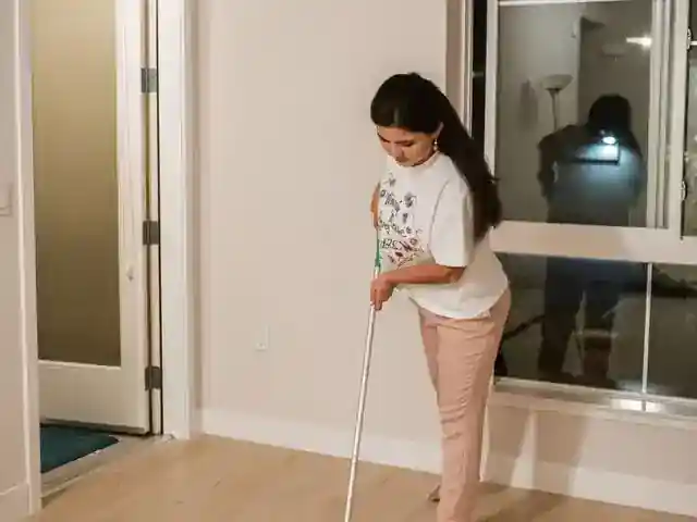 Cleaner mopping a kitchen floor during recurring house cleaning